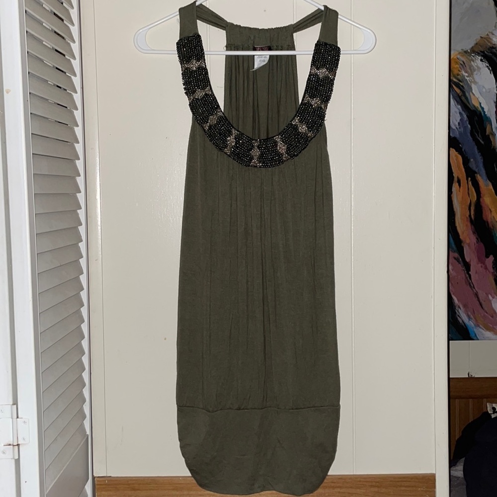 Green top for ladies with beads around the collar. Size L